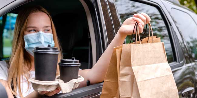 Food delivery home. Covid 19, quarantine. Contactless delivery in a pandemic. Safety. Delivery courier with order.curbside pickup