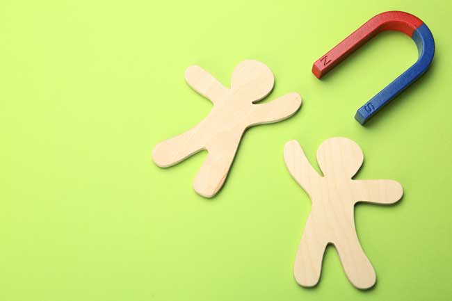 Magnet attracting people traffic on color background