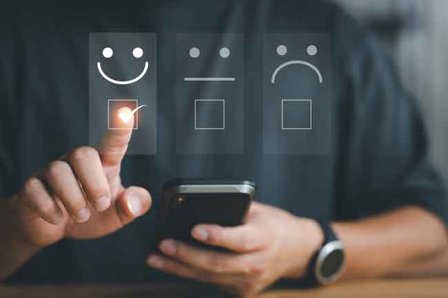 Customer service evaluation concept. Businessman pressing face smile emoticon show on virtual screen at smartphone