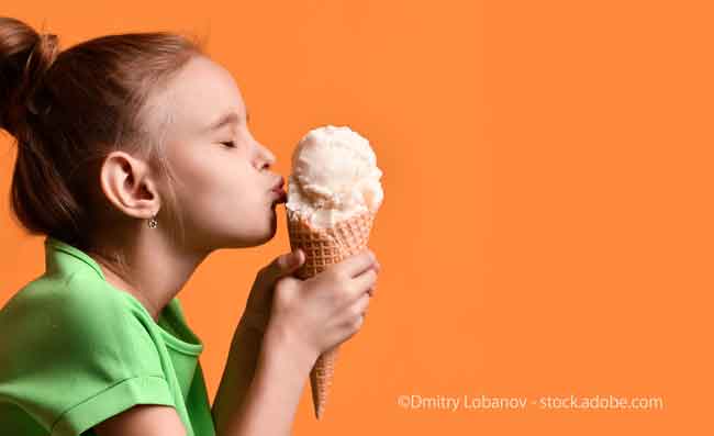Little baby girl kid kissing vanilla ice cream in waffles cone