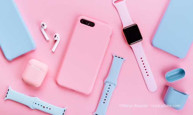 Up to date technology.Top view of diverse personal accessory laying on the pink background