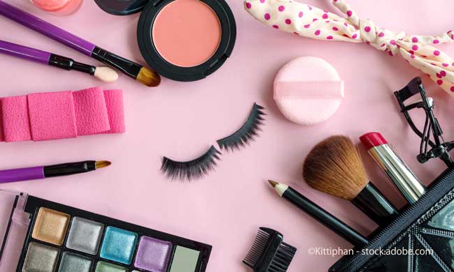 various makeup products and cosmetics isolated on pink