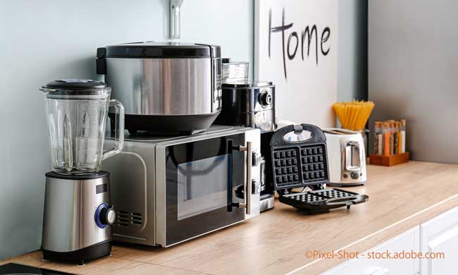 Different household appliances on table in kitchen