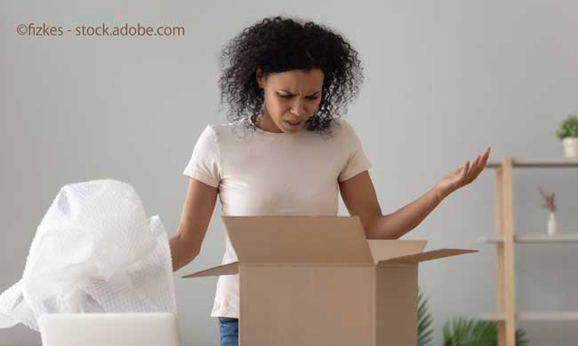 Disappointed shocked african woman open cardboard box receive bad parcel
