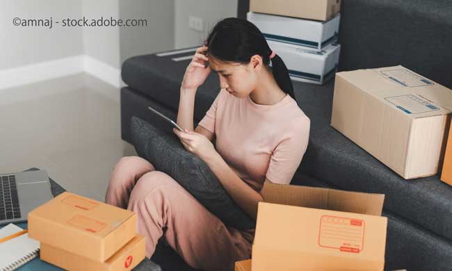 Young Asian business woman look at their laptop and stressed about declining online purchase at home
