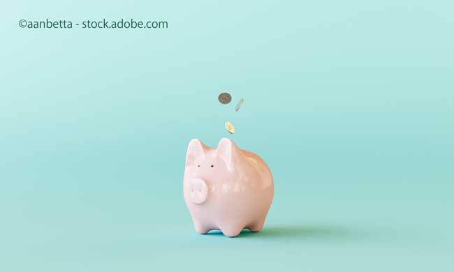 Pink piggy bank with coins