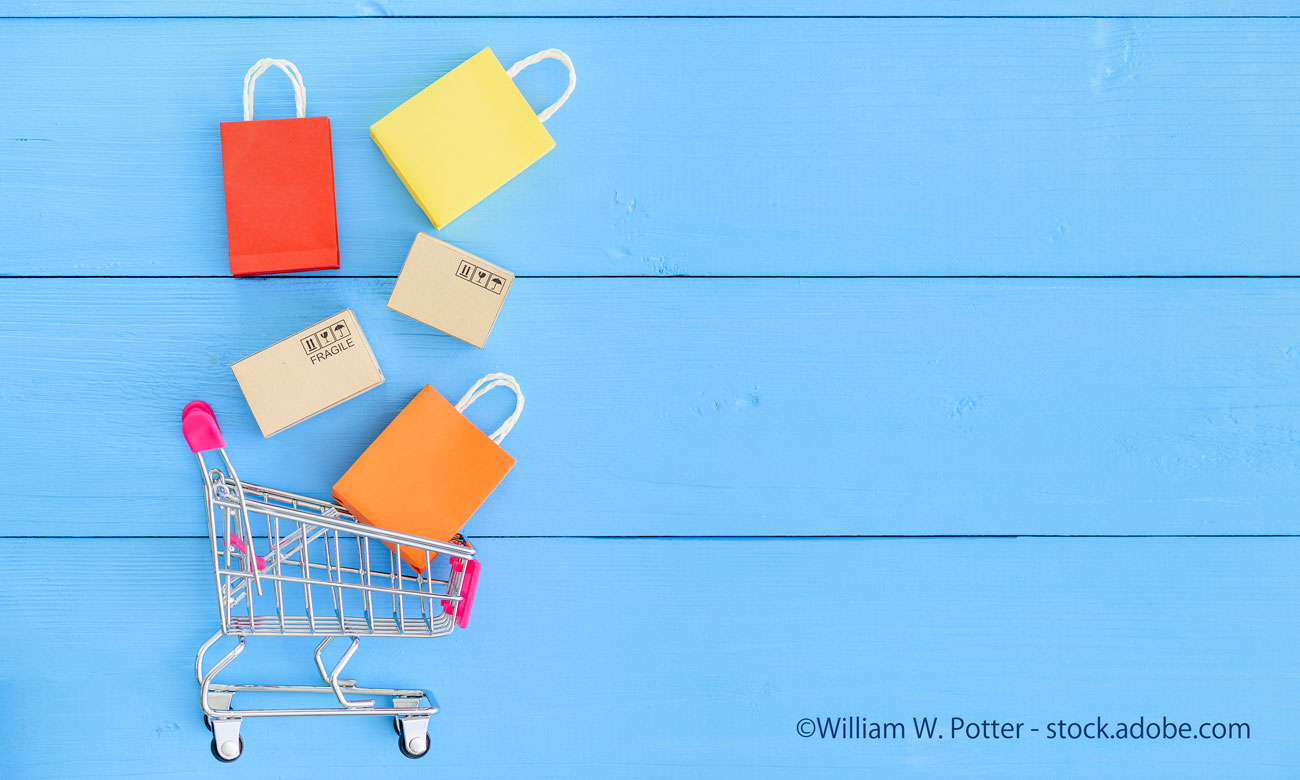Shopping cart with boxes, colored shopping bags