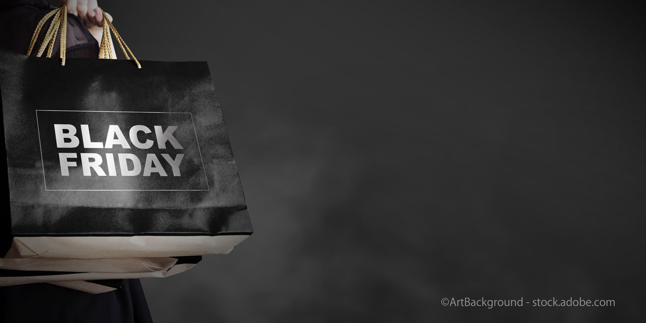 Black friday sale concept of young woman holding shopping bag