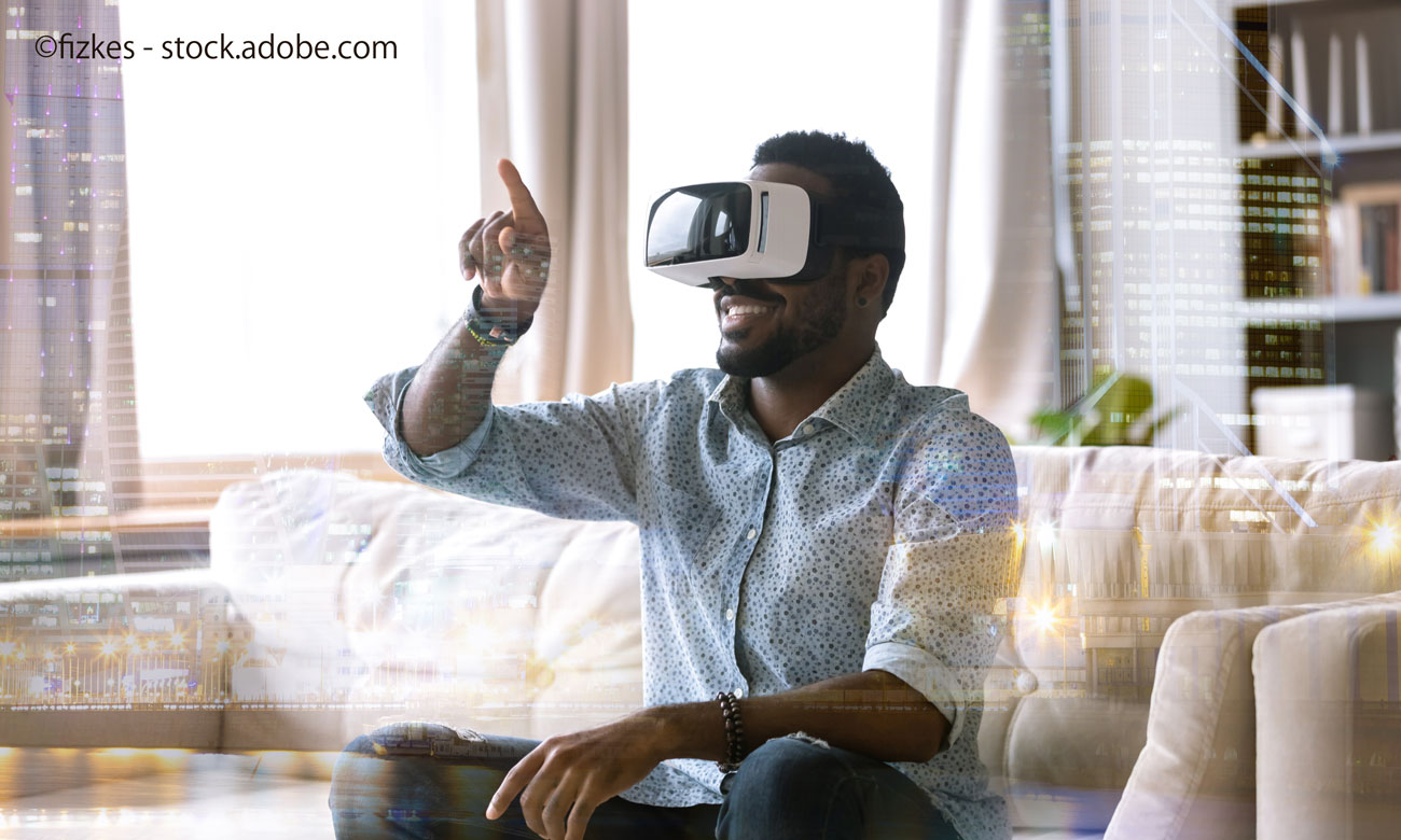 Excited young african american man wearing virtual reality glasses