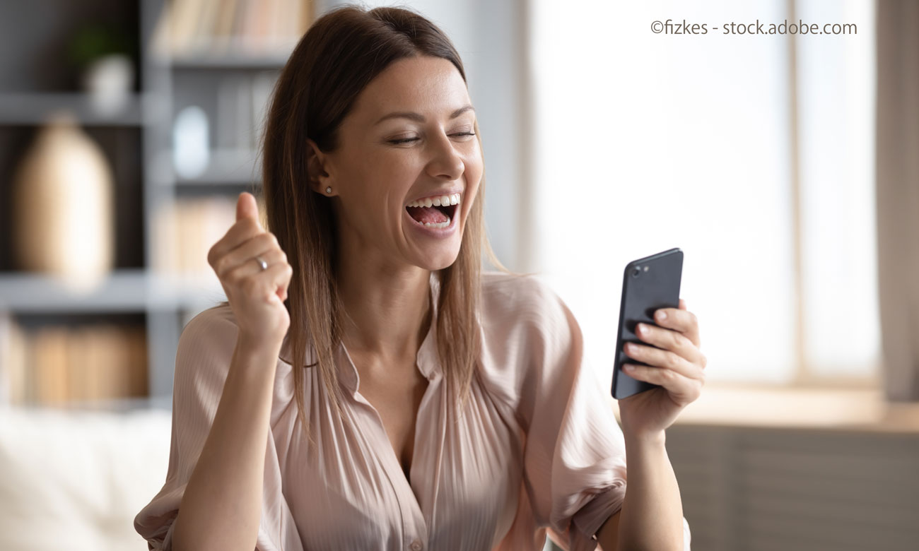 Excited happy woman looking at phone screen