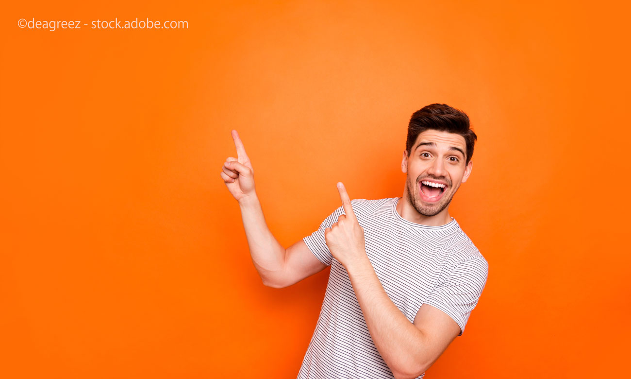attractive guy hold hands fingers direct up empty space excited good mood sales person 