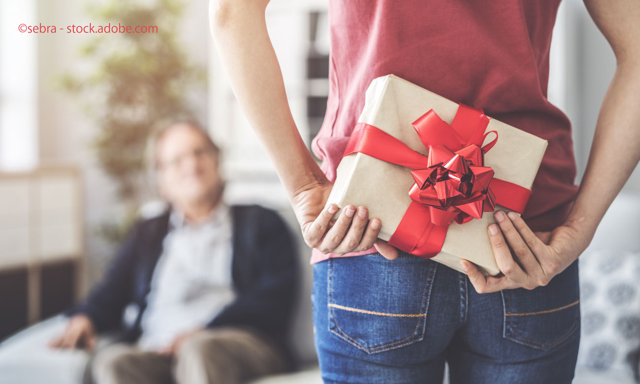 Young daughter gives her father a gift