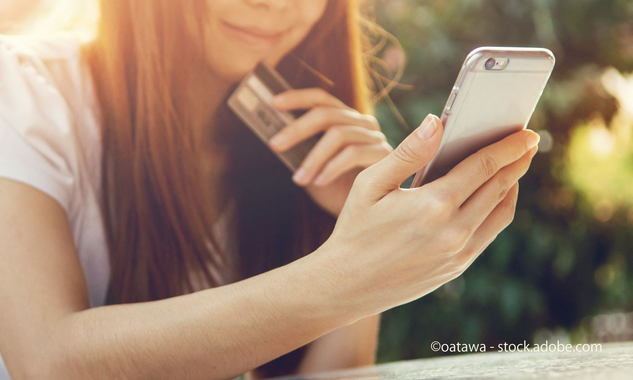 hands holding credit card and using mobile smart phone