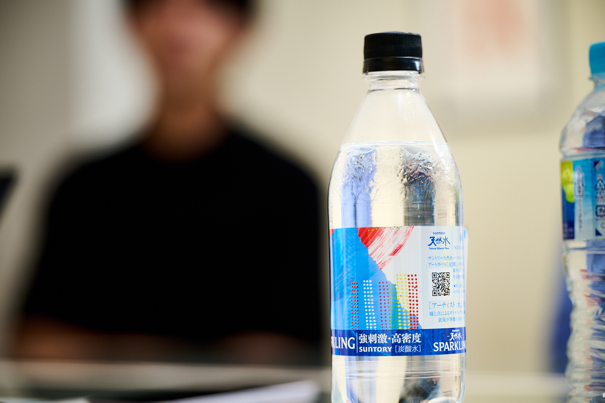 サントリー天然水 アートラベルの写真です。ラベルの裏面には作家への言及やQRがレイアウトされています